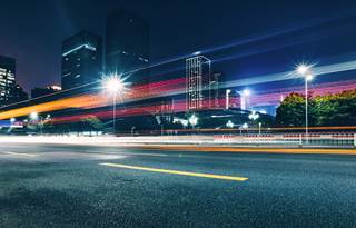 Picture of a downtown area road at night. 