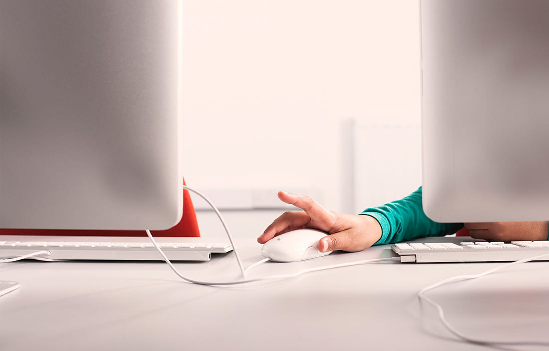 Image of person using computers for the K12 Technology Imperative Whitepaper