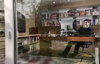 Businessman sitting at desk using computer. 