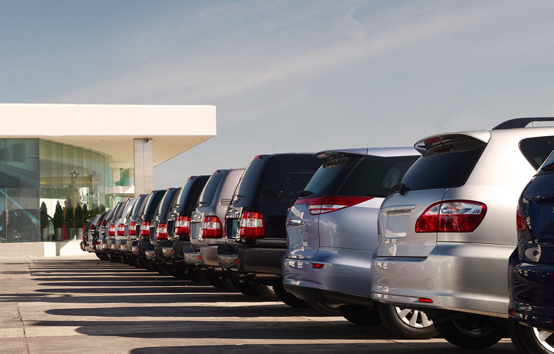 Row of vehicles at a car dealership.