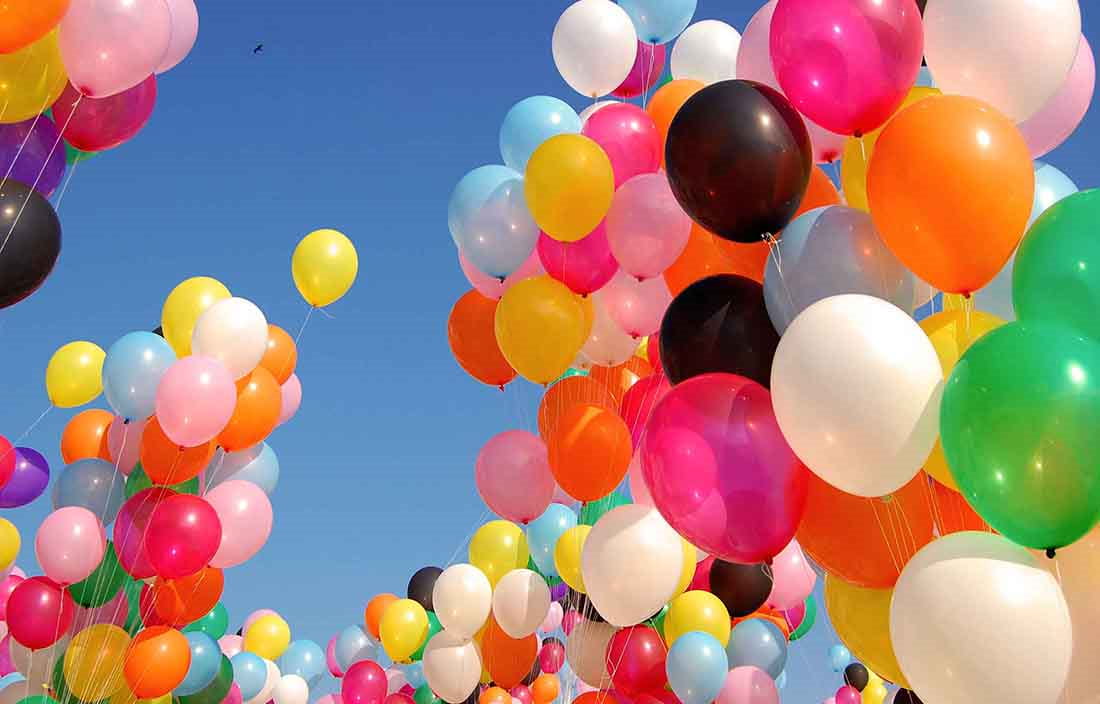 Photo of balloons floating in the air.