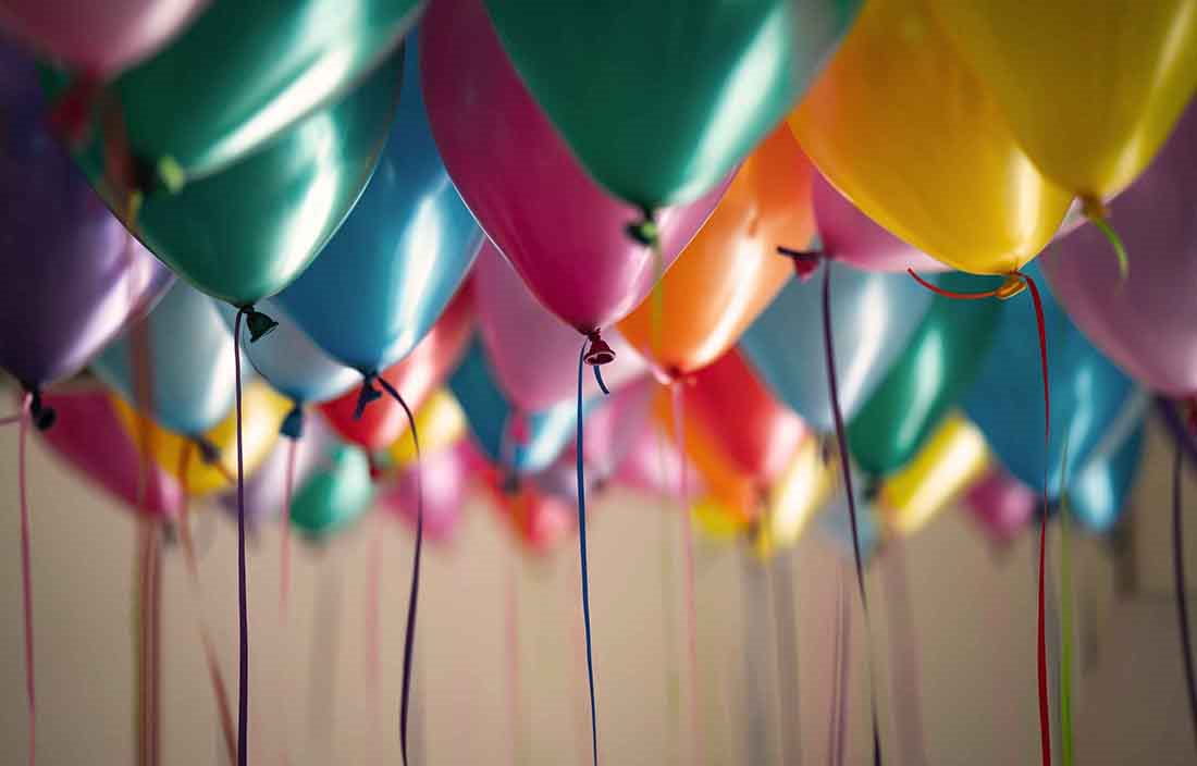 Close-up view of balloons floating in the air.