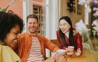 Group of millennials laughing and smiling.