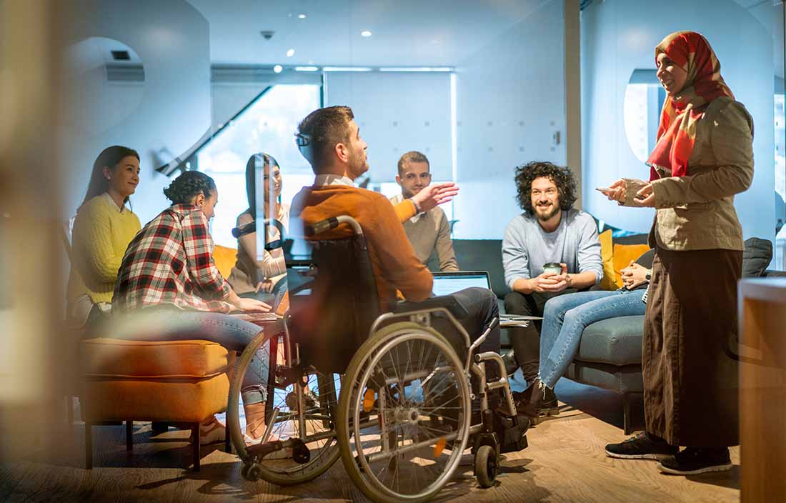 Group of coworkers chatting in break room.