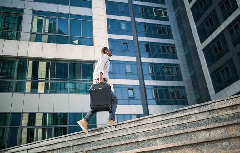 IT professional walking up stairs.