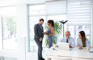 Group of business professionals working in a modern office.