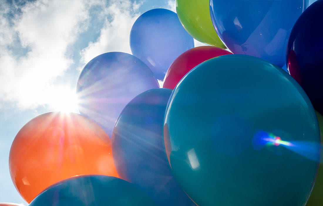 Colorful balloons floating into the sky.