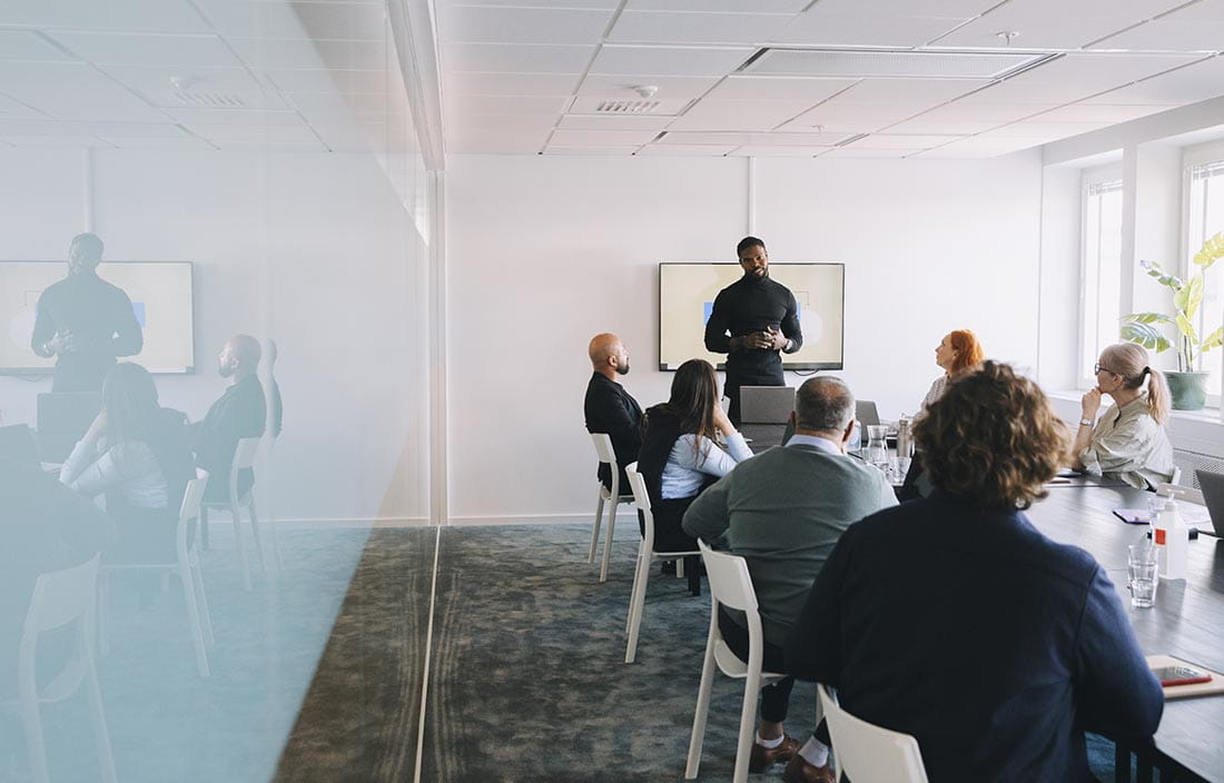 Group of business professionals meeting in a modern conference room.