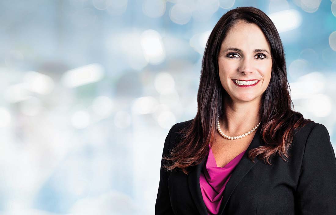 Professional photo of Angela Appleby in front of a blurred white and blue background.