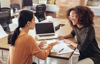 Two accountants chatting at work.