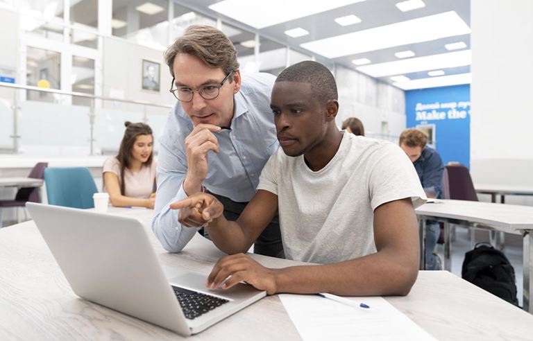 Two business professionals working on their laptop computer.