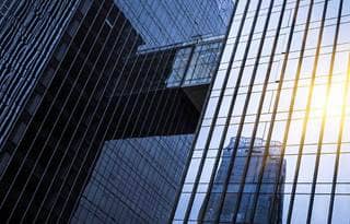 Sun shining in the reflection of a glass building.