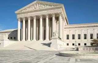View of U.S. government building against a clear blue sky.