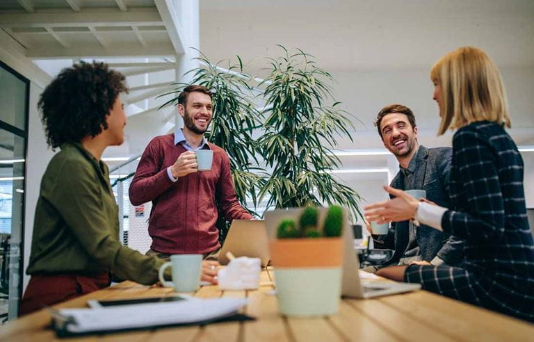 Group of coworkers chatting at the office.