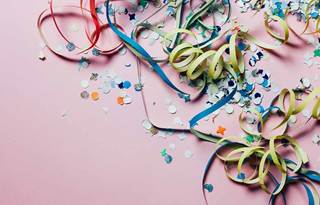 Confetti against a pink background.