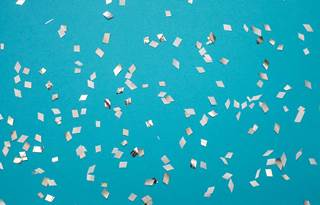 Confetti on a bright blue background.