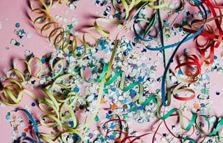 Confetti against a pink background.