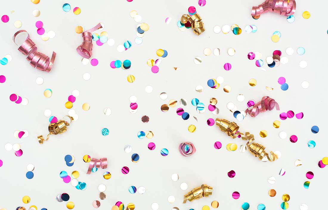 A close up of celebration confetti with a white background