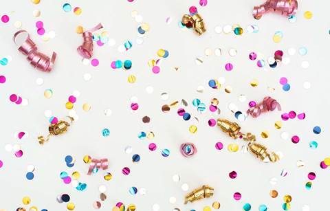 A close up of celebration confetti with a white background