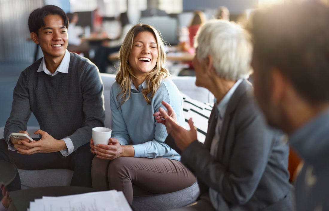 Business professionals talking and laughing together.