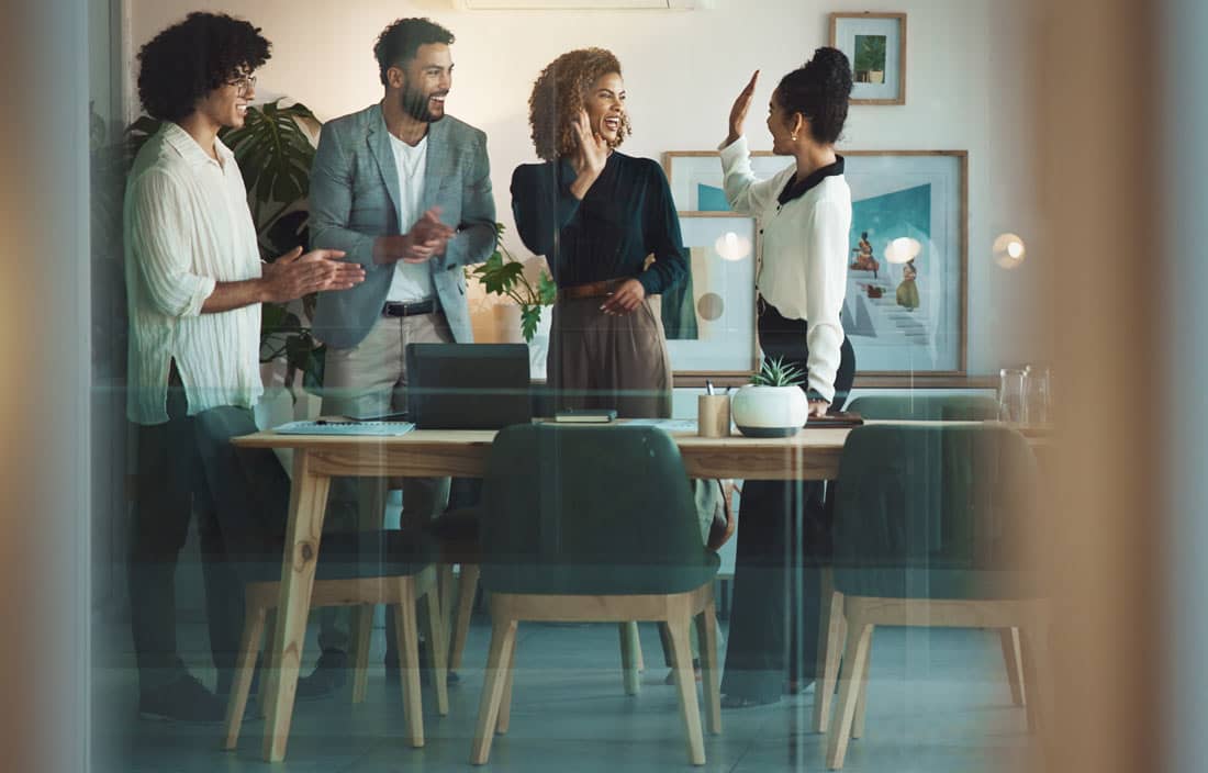 Business professionals smiling and celebrating an award.