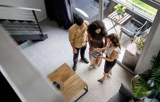 Coworkers talking in a modern office building.
