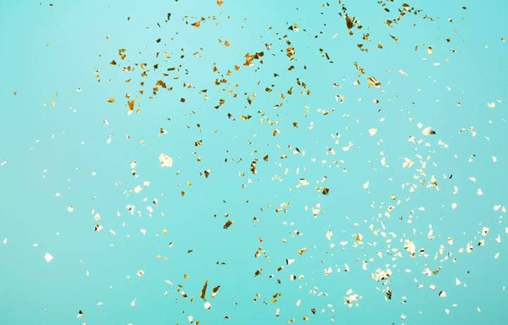 Confetti against a light blue background.