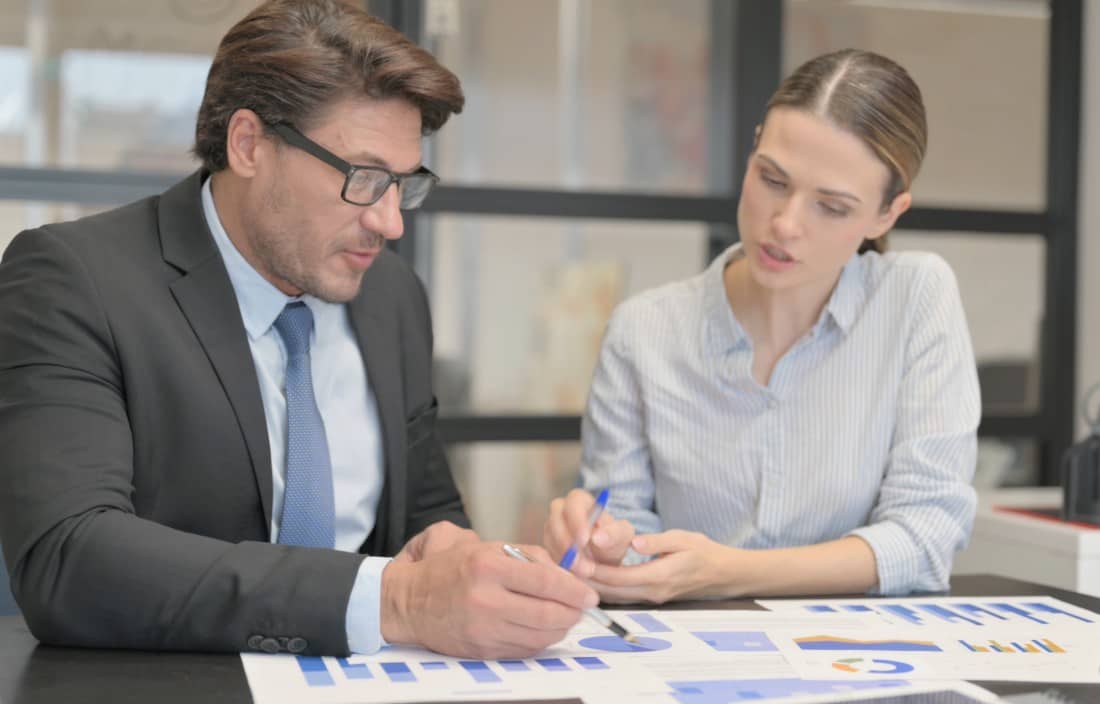 Business professionals discussing AI in a meeting.