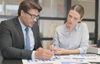 Business professionals discussing AI in a meeting.