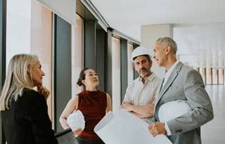 Construction experts talking with consultants.