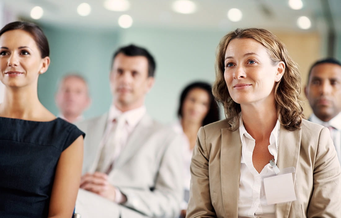 An audience listens to a presentation. 