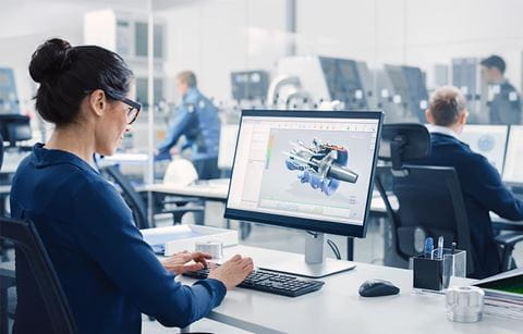 Woman working on a computer in engineering and design company's new office space