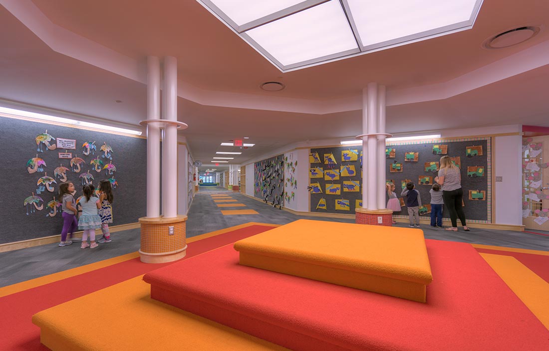 Novi Community School District Early Childhood Center lobby area with colorful seating area and walls with kids' artwork