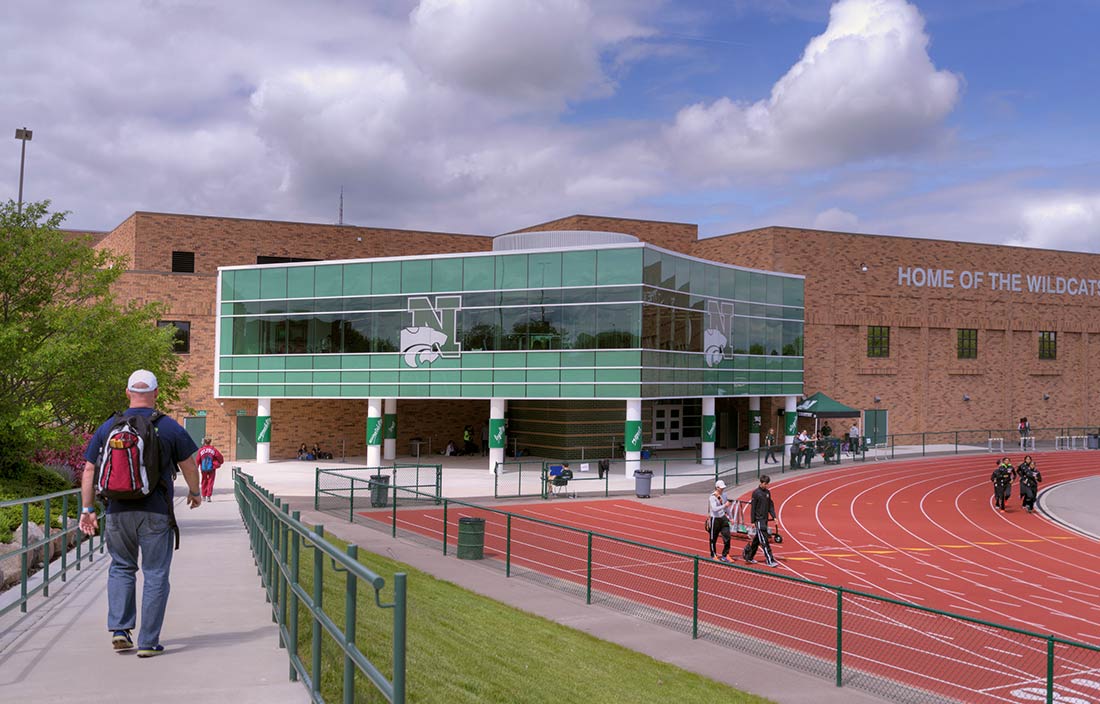 Novi Community School District high school athletic building and track, as seen from outside