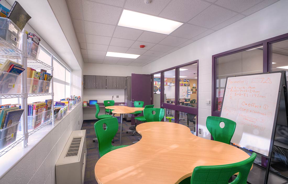 Novi Community School District small group instruction room with odd-shaped tables and a whiteboard