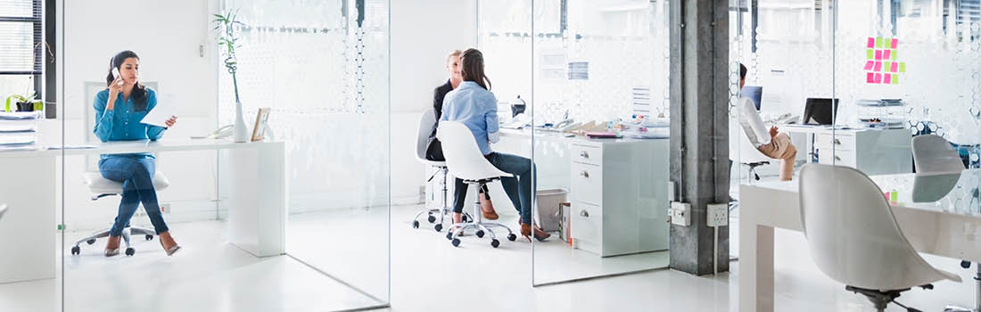 Image that show workers in huddle rooms, taking calls and working in private groups