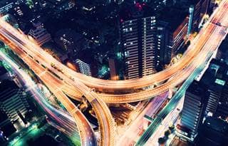 Overhead time lapse image of a freeway at night with car lights