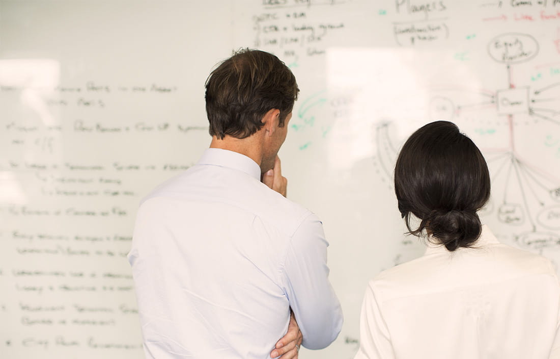 Coworkers at whiteboard