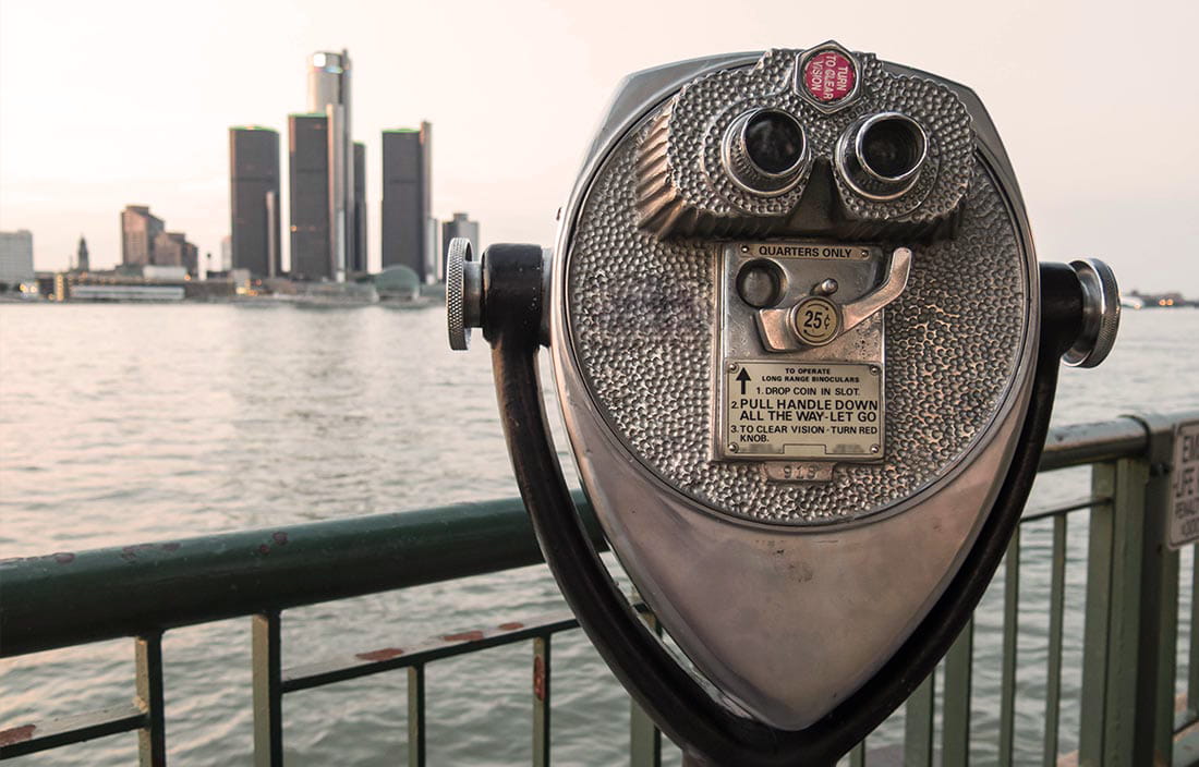 Image of Detroit skyline in background with a viewer in the foreground