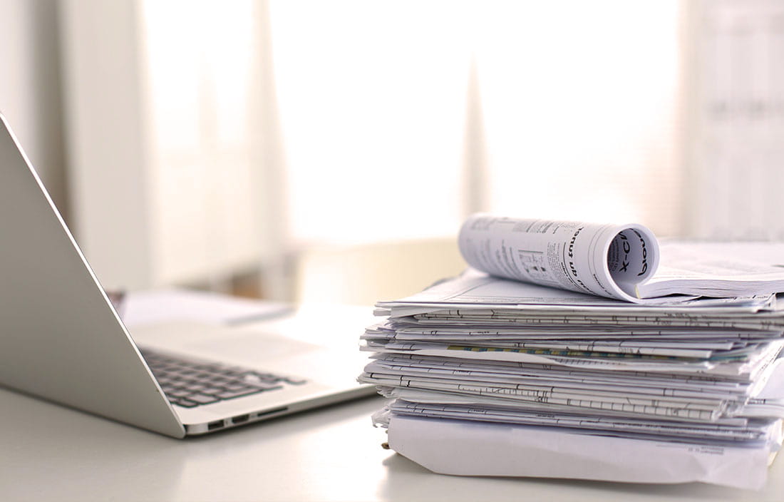 Image of laptop and papers to represent accounting client