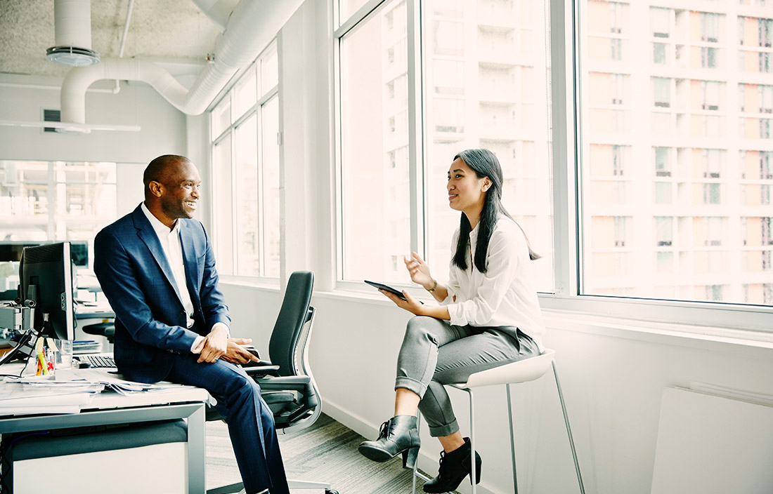 Image of 2 people in open, well-lit office