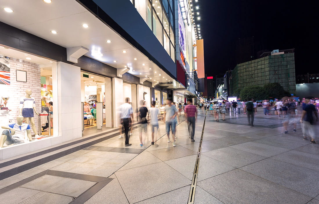 Street view with time lapse of people walking in front of stores