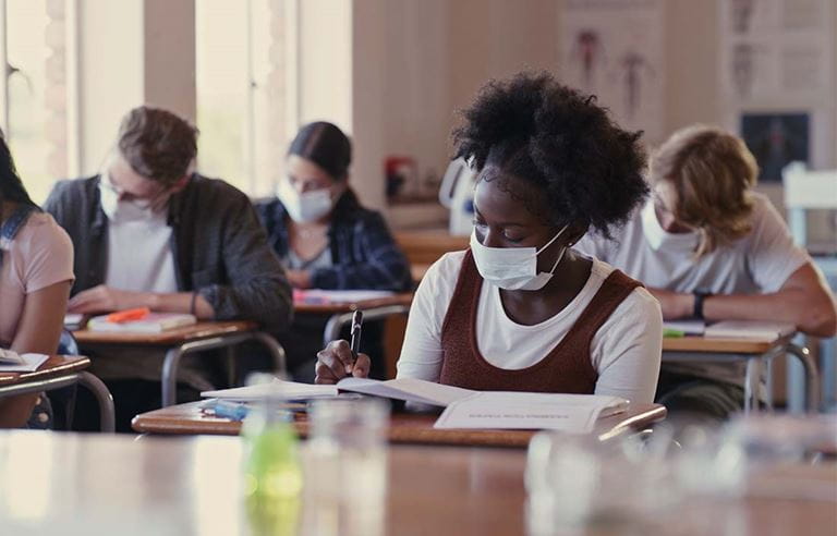 Groups of high school students working in a classroom