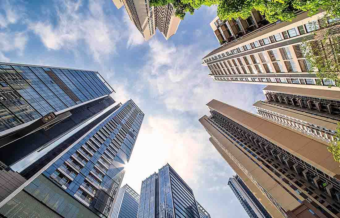 Photo of skyscrapers from the perspective of the ground, looking up to the sky