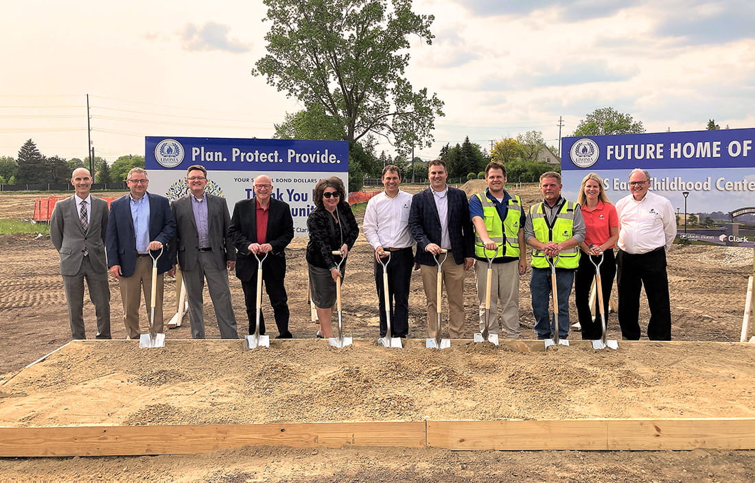 Livonia Public Schools Early Childhood Center Groundbreaking ceremony with district and project staff posing with shovels