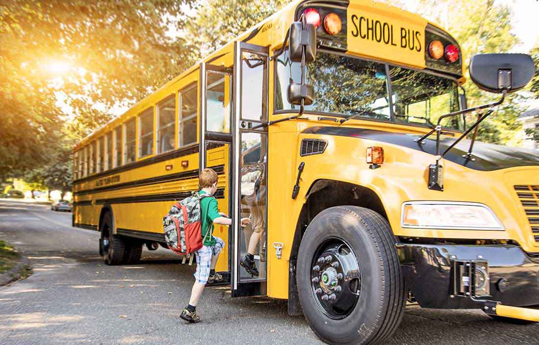 Elementary student entering a school bus