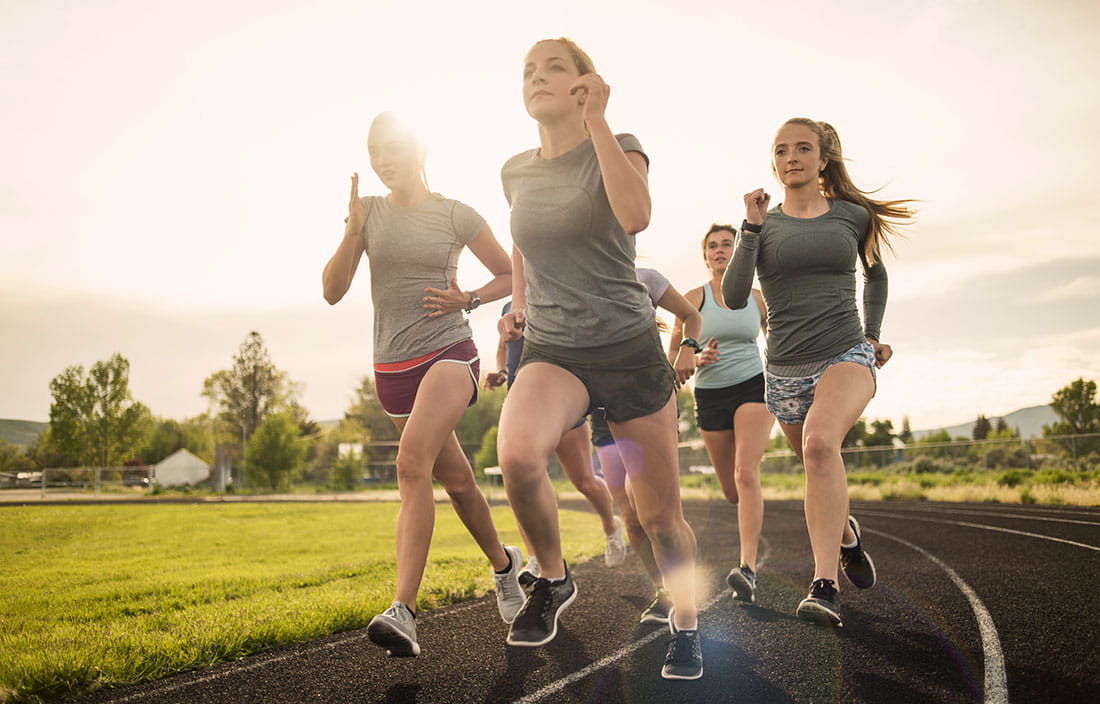 teenage girls running on a track
