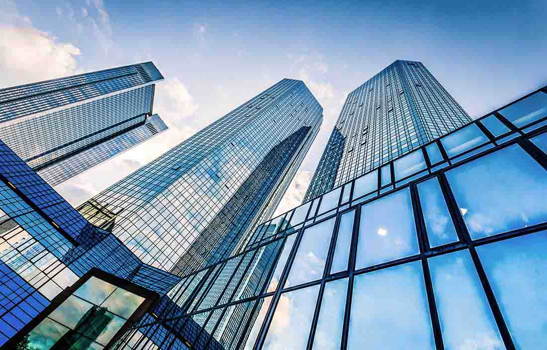 Looking up from the ground at office real estate buildings