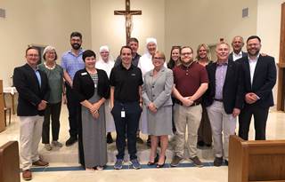 Project team for Little Sisters of the Poor redevelopment prosing at the front of the reopened chapel