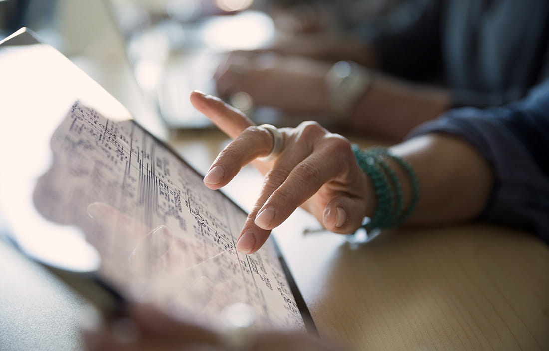 Woman working with data on a tablet device